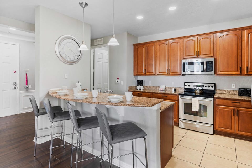 Our fully equipped kitchen boasts modern amenities and ample space for culinary adventures. The breakfast bar provides a cozy spot for casual dining or socializing while enjoying delicious meals prepared with ease.