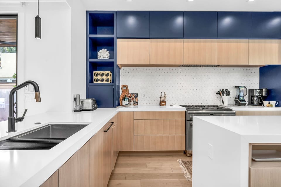 This professionally designed chef's dream kitchen is equipped with high-end GE Cafe stainless steel appliances, custom built cabinetry and a 10’ island