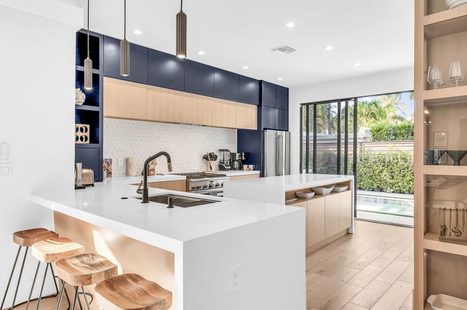 This professionally designed chef's dream kitchen is equipped with high-end GE Cafe stainless steel appliances, custom built cabinetry and a 10’ island