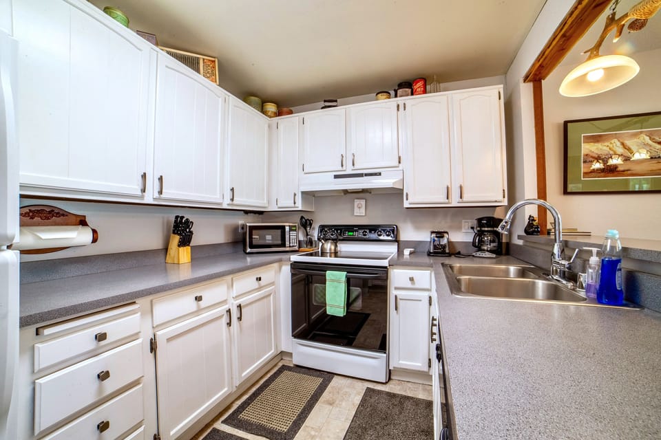 Kitchen has plenty of cabinets and storage.