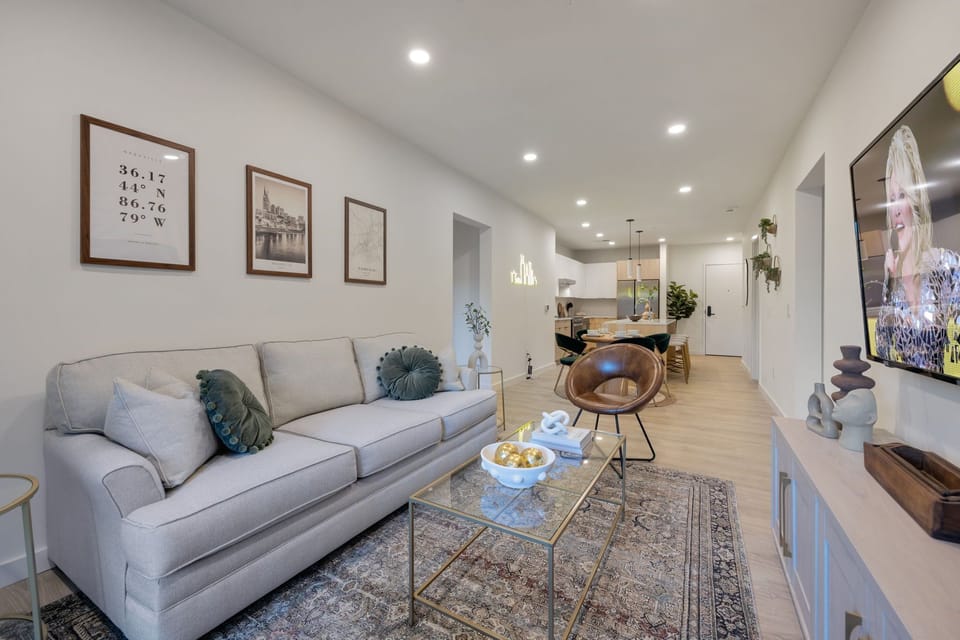 Open-concept floor plan seamlessly flowing the living room, dining area and fully equipped kitchen into one large space to keep your group together.