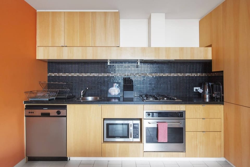A fully-equipped kitchen lines the back wall and offers all the contemporary appliances including a gas stove, oven and more