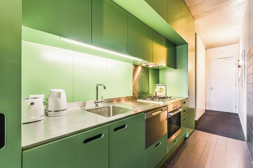 The lime green kitchen is fully-equipped with appliances, a dishwasher and all the essentials you need to cook at home