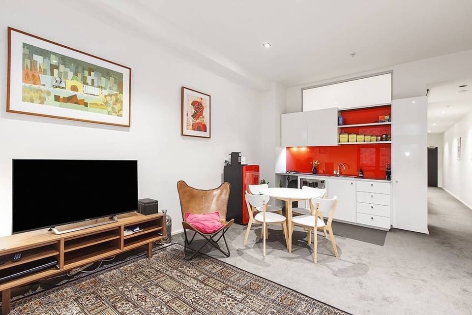 A contemporary kitchen has modern appliances including a small fridge, microwave, gas stove, oven and all the basic cooking utensils 