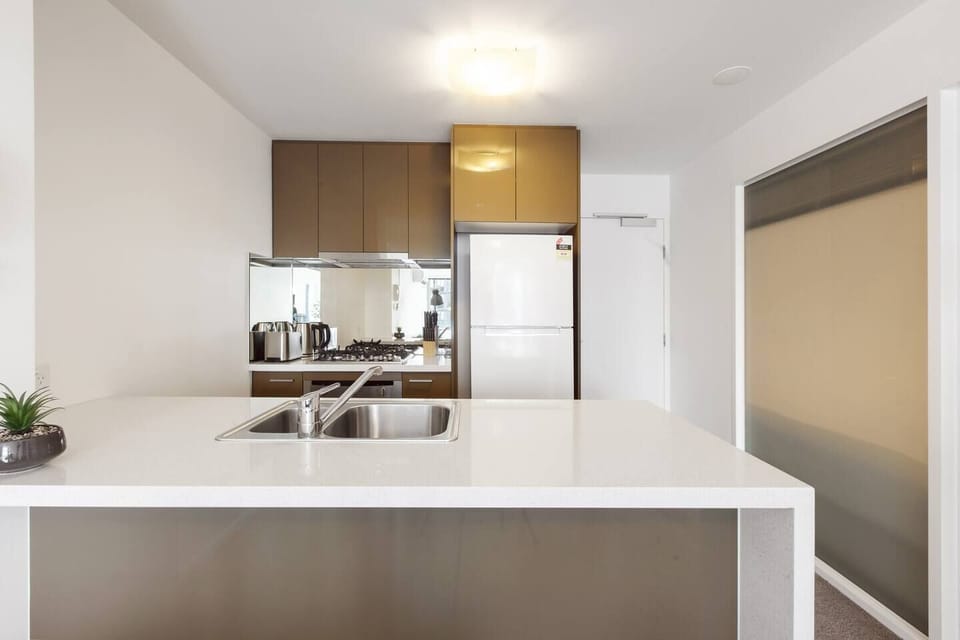 The stylish kitchen is equipped for all your cooking needs with a fridge, stove, oven, kettle and toaster.