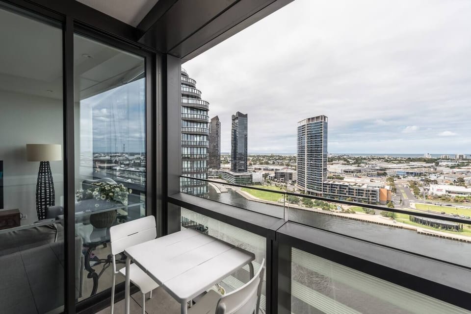 The master bedroom has the luxury of access to a cozy, private balcony with outdoor seating