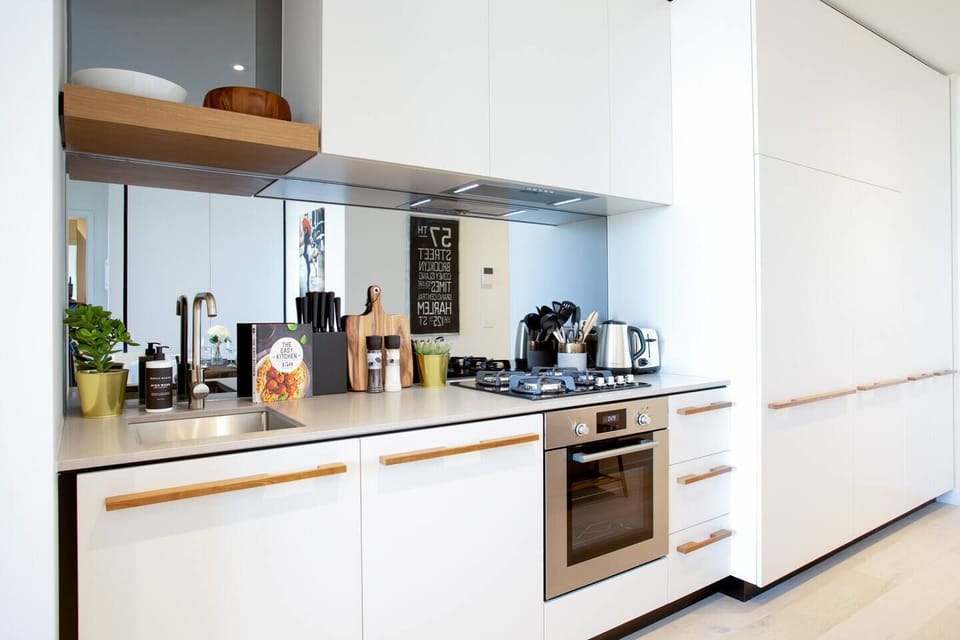The well-equipped kitchen is ultra-modern and fitted out with quality appliances including a stove, oven, kettle and toaster