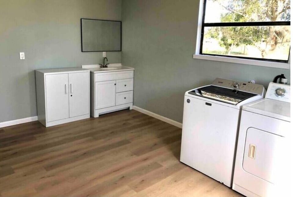 Extra vanity sink in laundry room. 