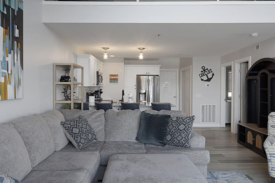 Sink into your plush sectional and feel instantly at home in this bright, coastal-themed space where comfort meets modern style.
