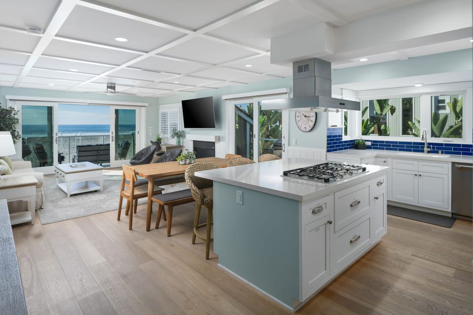 This living space includes a sleek, modern kitchen with a central island perfect for casual seating and gatherings.