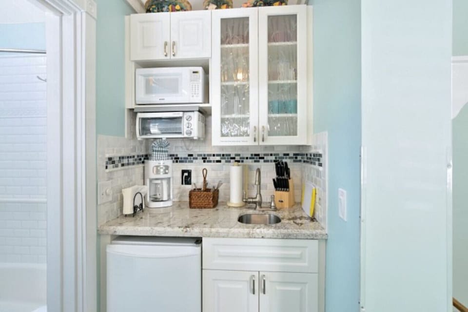 Efficiency kitchen with frig, microwave, toaster/oven, blender, coffee maker, electric skillet and utensils.  Coffee, sugar, creamer, salt/pepper, all paper supplied included.