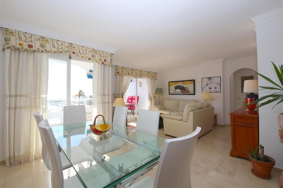 Full view of the bright lounge area with dining area for six guests