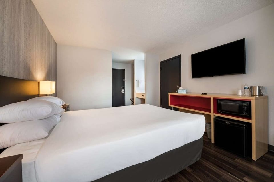 Recharge in a calm, minimalist room with soft bedside glow