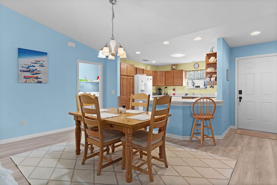 Gather around your dining table for meals and conversation in this open, light-filled space. The fully equipped kitchen flows seamlessly into your dining area, perfect for preparing and enjoying home-cooked favorites together.
