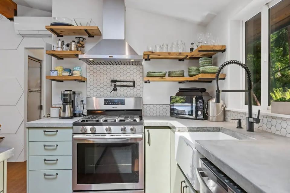 Fully equipped gourmet kitchen with stainless pots and pans and Shun knives