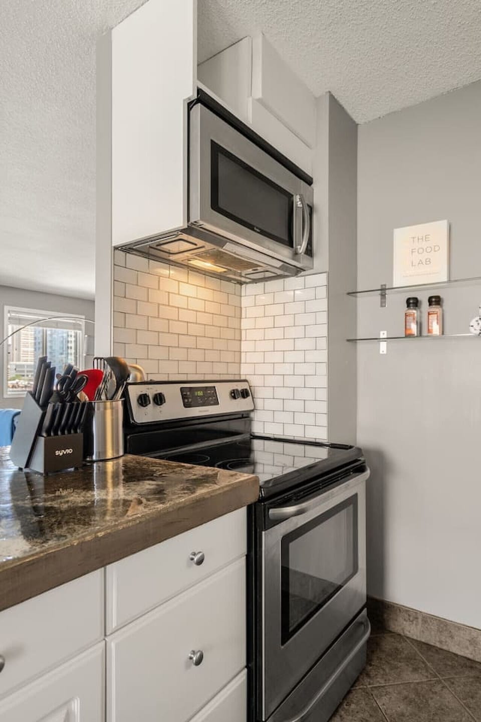 Experience the ease of home-cooked meals in our modern kitchen, fully equipped with utensils, a sleek induction stove, and a microwave, catering to all your culinary needs with finesse.