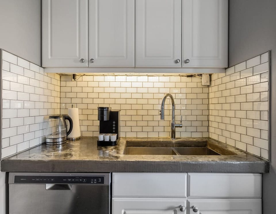 Maintain a tidy space effortlessly with our designated cleaning area, featuring a high-efficiency dishwasher that takes care of the clean-up so you can focus on enjoying your stay.