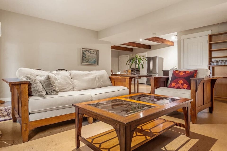 Living room with sofa facing gas fireplace.
