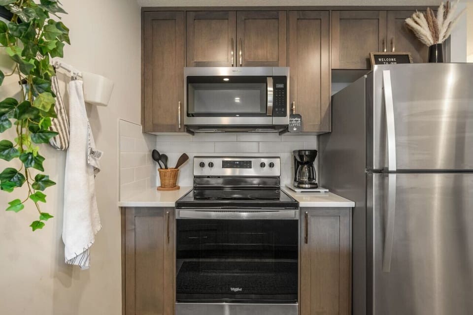 Fully loaded kitchen with fridge, microwave and all essential dinnerware