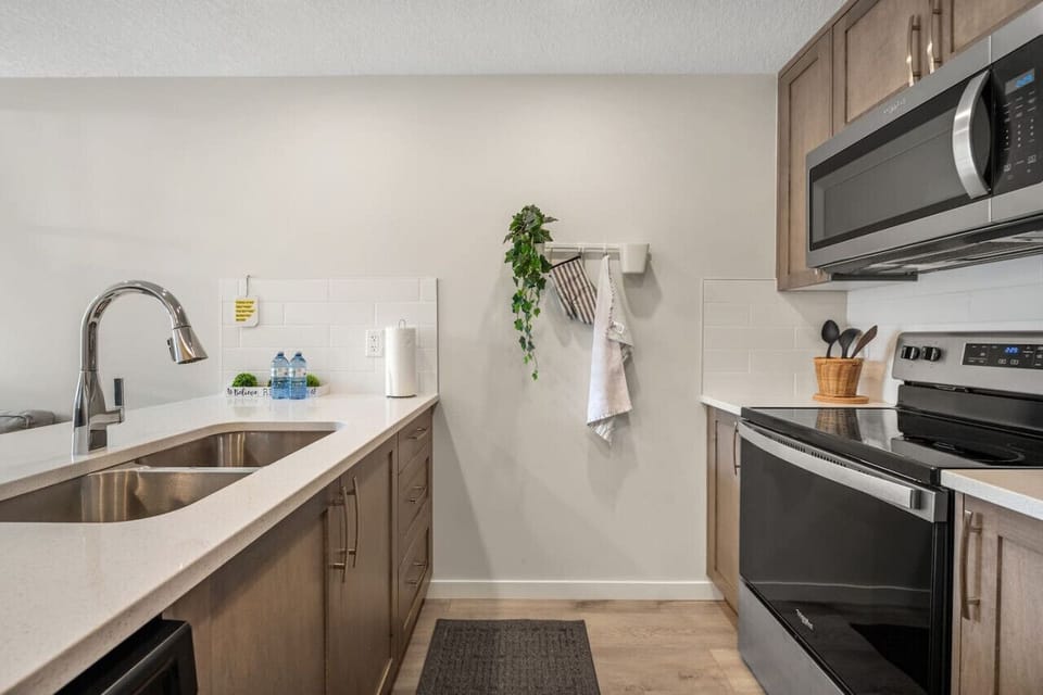 Fully loaded kitchen with fridge, microwave and all essential dinnerware