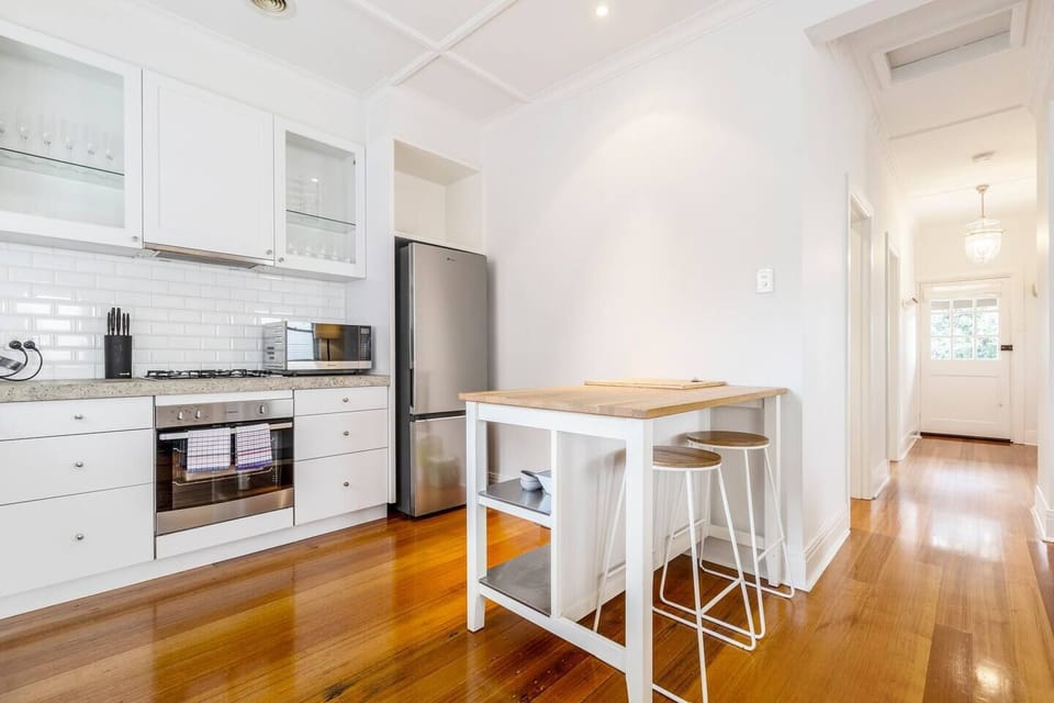 The kitchen is fully-equipped with everything you need to cook meals at home, while an island offers seating to dine in.
