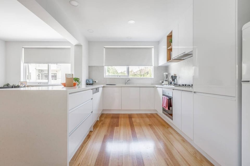 A modern and spacious kitchen is fit with modern appliances, including a gas stovetop, full-sized fridge, dishwasher, oven.