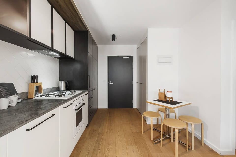 The fully-equipped kitchen is fitted with modern cons, stone bench tops and high end appliances. Eat your meals at the four person table