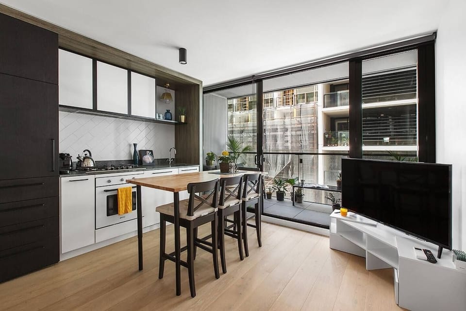 Open plan living and dining flows out to the private, furnished balcony.