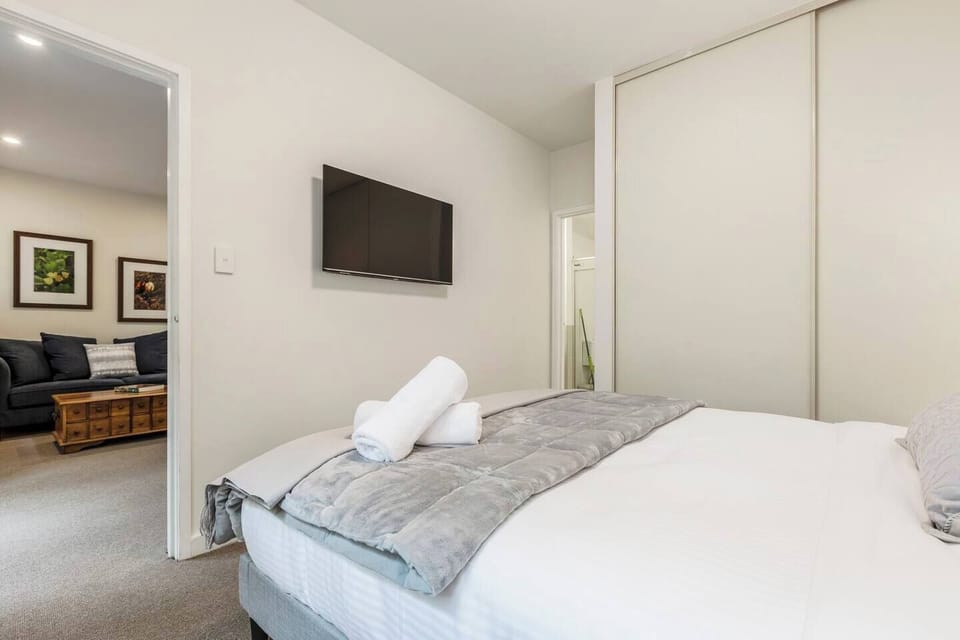 A second TV in the bedroom allows for easy viewing from bed.