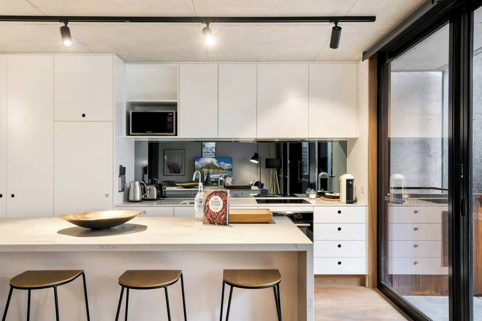 The main living area flows out to the patio, which faces the communal courtyard.
