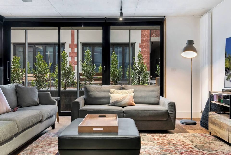The lounge room offers plus sofa seating in front of a flat-screen TV.