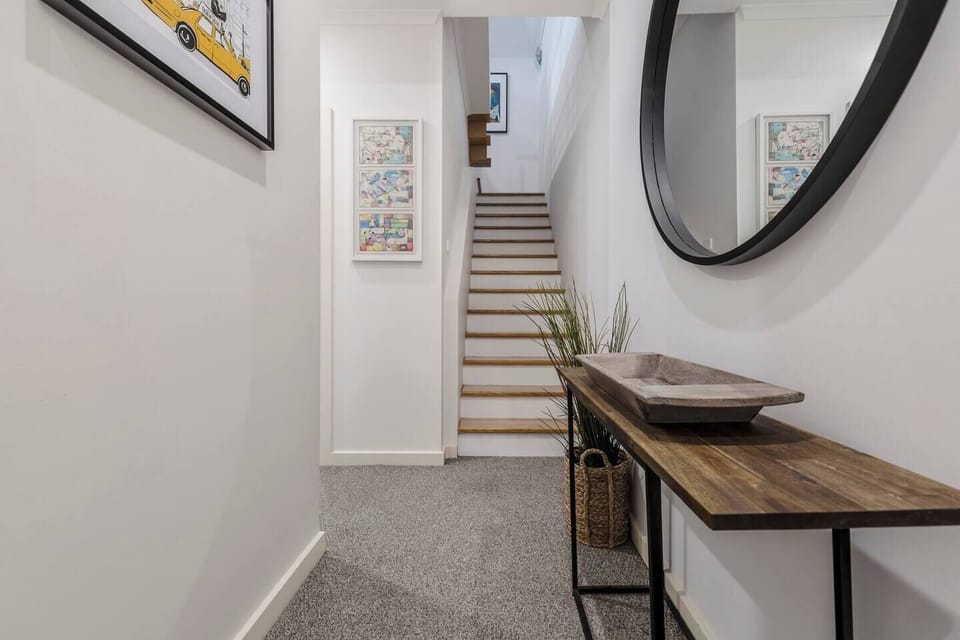 Guests are greeted downstairs with two bedrooms and a bathroom, then an open-plan kitchen, dining and living area upstairs. 
