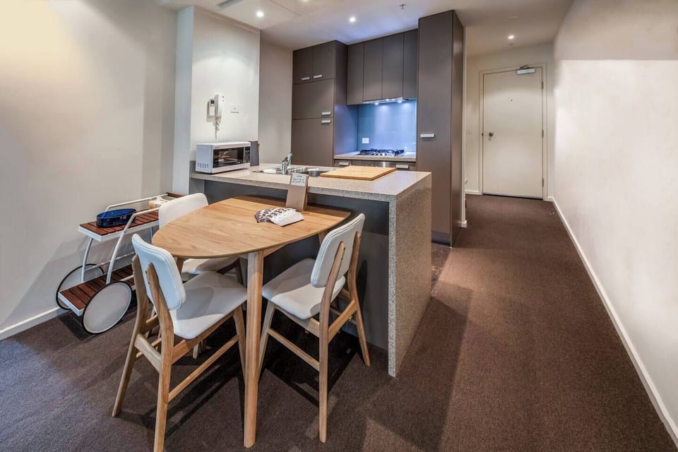 A fully-equipped kitchen that is fitted with appliances including a dishwasher, large fridge, oven, microwave and a gas stovetop