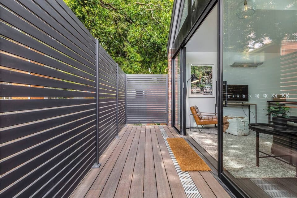The living room opens to the deck, filling the space in lovely natural light and fresh breezes.
