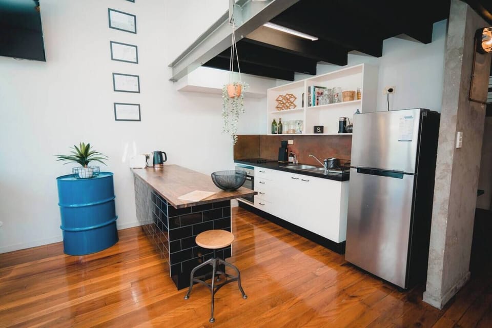 The industrial kitchen has everything you'd need to enjoy a quick brekkie or entertain some guests. 