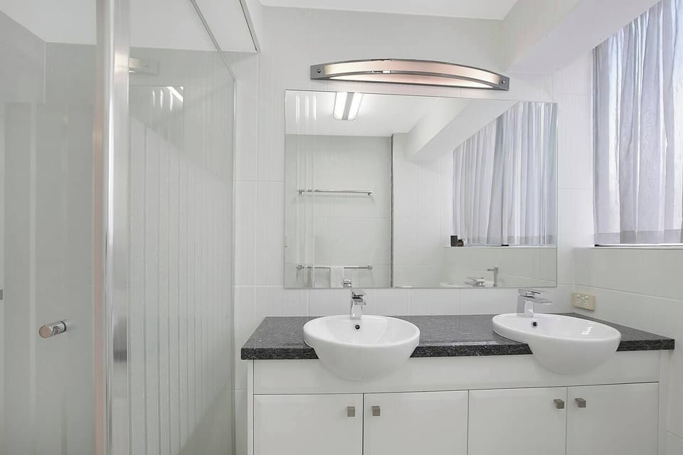 The main bathroom is well presented with a double vanity and shower to help refresh.
