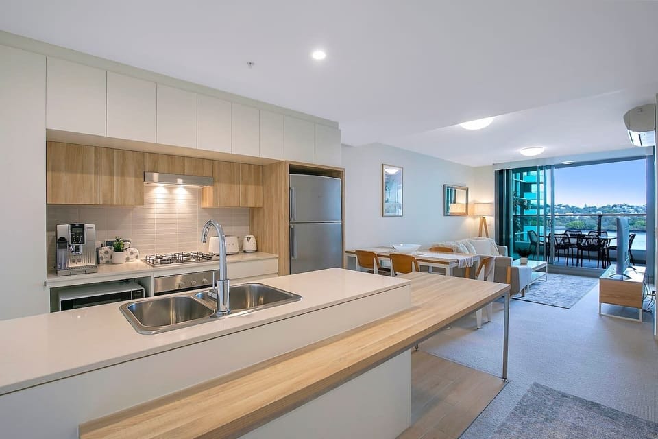 The kitchen and dining area sits in the comfort of air conditioning or the cool breeze from the balcony sliding doors. 
