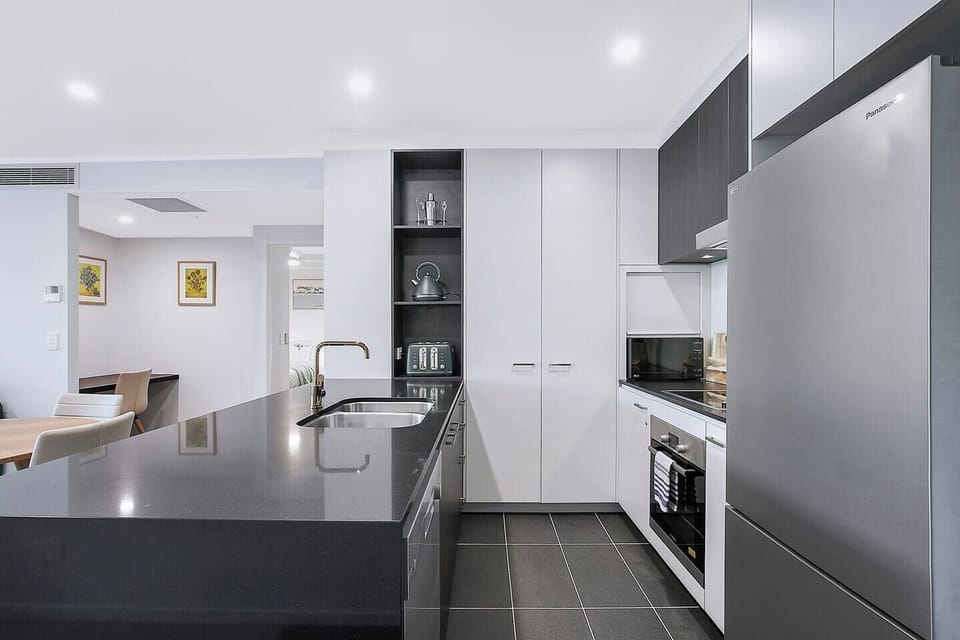 A modern kitchen offers all the essentials needed to prepare meals at home, plus a dishwasher for easy clean-up. 
