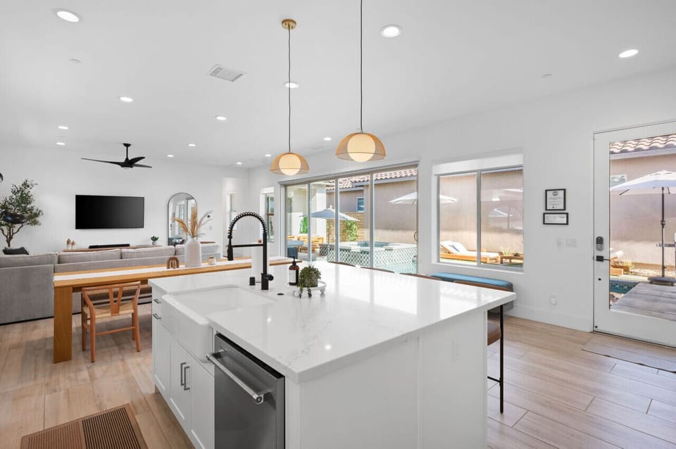 Bright kitchen w/ large island, bar seating & views into the living area