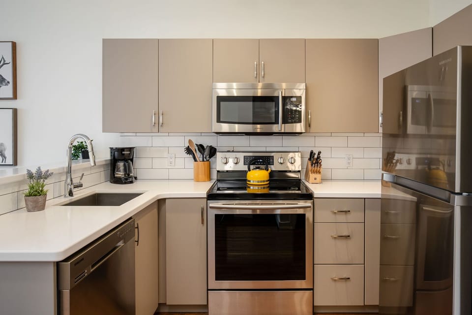 A fully equipped kitchen with sleek stainless steel appliances awaits your inner chef.