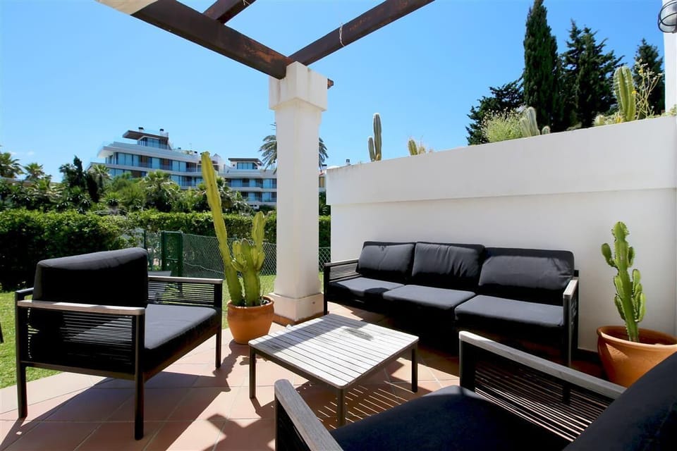 Outdoor seating area for five guests with views to the garden