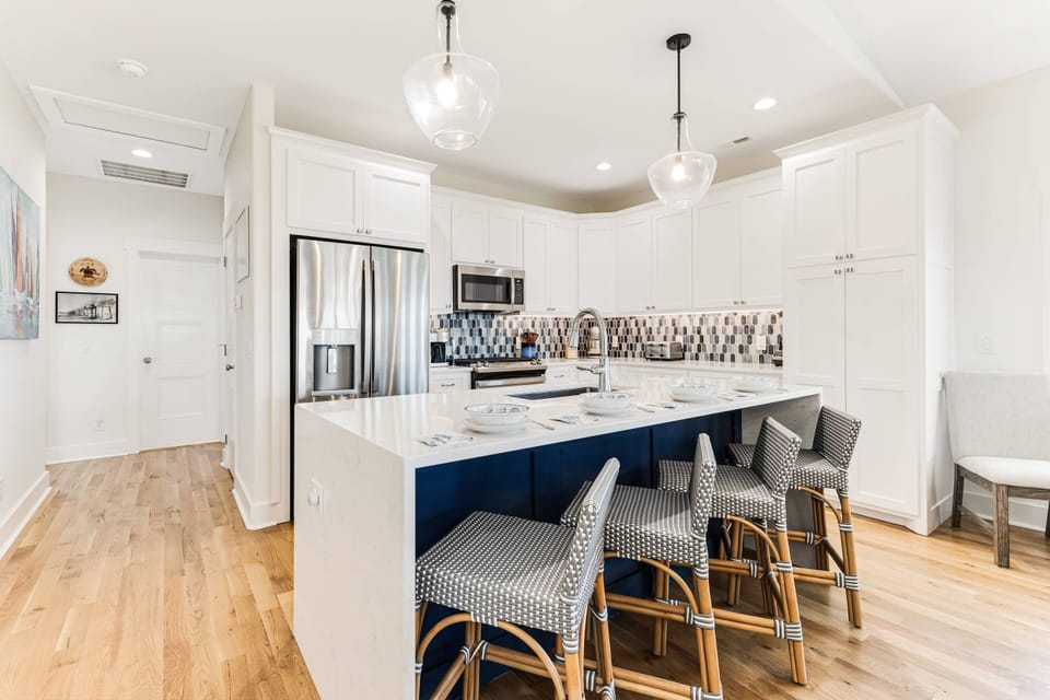 The island in this kitchen can have a variety of uses: breakfast bar, prep space, buffet & with an outlet on the end, a mobile work/school space.