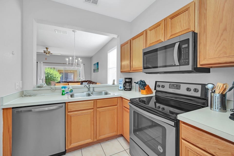 A view of the kitchen entry with clean tile flooring and a practical layout for cooking.
