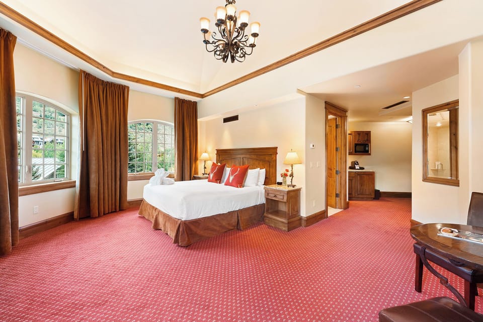 Recharge in a generous bedroom with warm lighting and space.