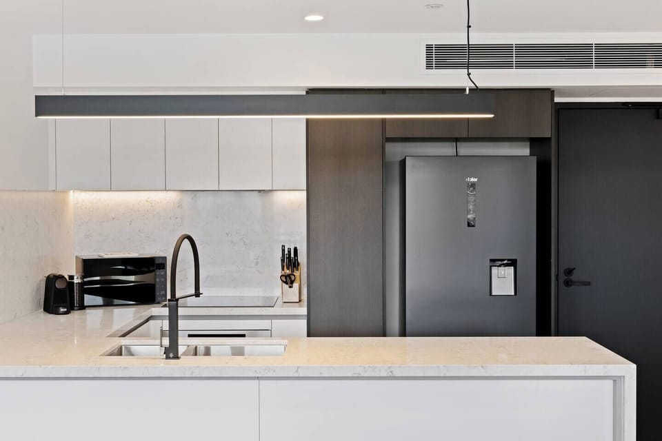 The layout seamlessly connects to the living and dining areas, making it ideal for social cooking and entertaining.