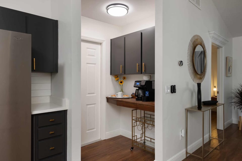 Start your day right at our dedicated coffee station, complete with a professional brewer and a stylish bar setup. Grab a fresh cup and a pastry before heading out, or enjoy the quiet morning light in this beautifully curated transition space.