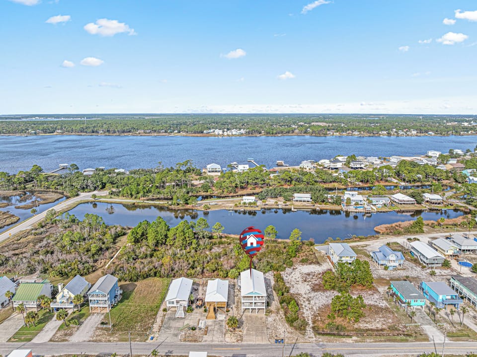 Aerial view showcasing the home’s location along the lagoon, offering peaceful water views and a relaxed coastal setting. Ideally situated between the lagoon and the Gulf