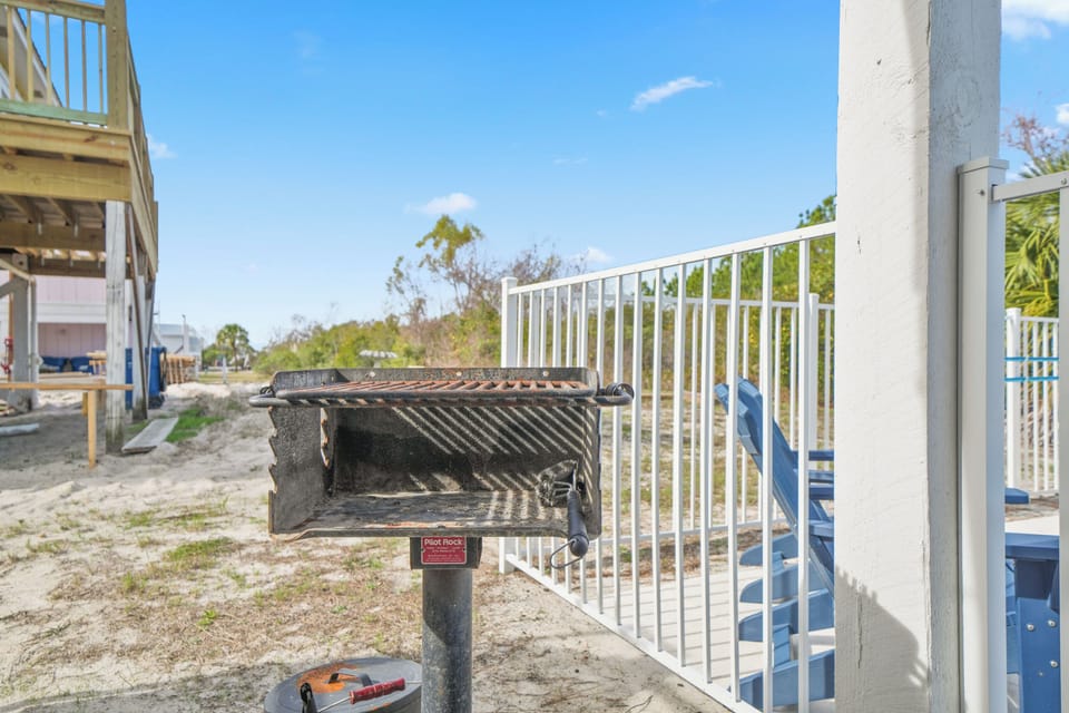 charcoal grill area located poolside—perfect for casual cookouts and easy outdoor meals. Conveniently situated near the pool, outdoor bar, and seating areas.