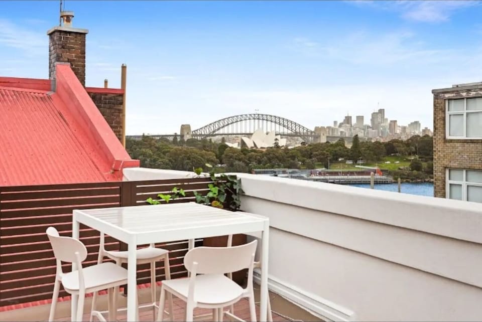 Unwind on the shared rooftop with front-row views across Sydney Harbour, where the Harbour Bridge, Opera House, and glittering skyline create a spectacular backdrop for slow mornings or sunset drinks above the water.