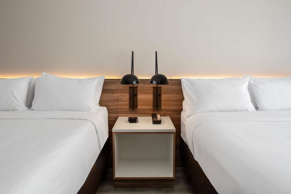 Drift off easily with warm bedside lighting and crisp linens.